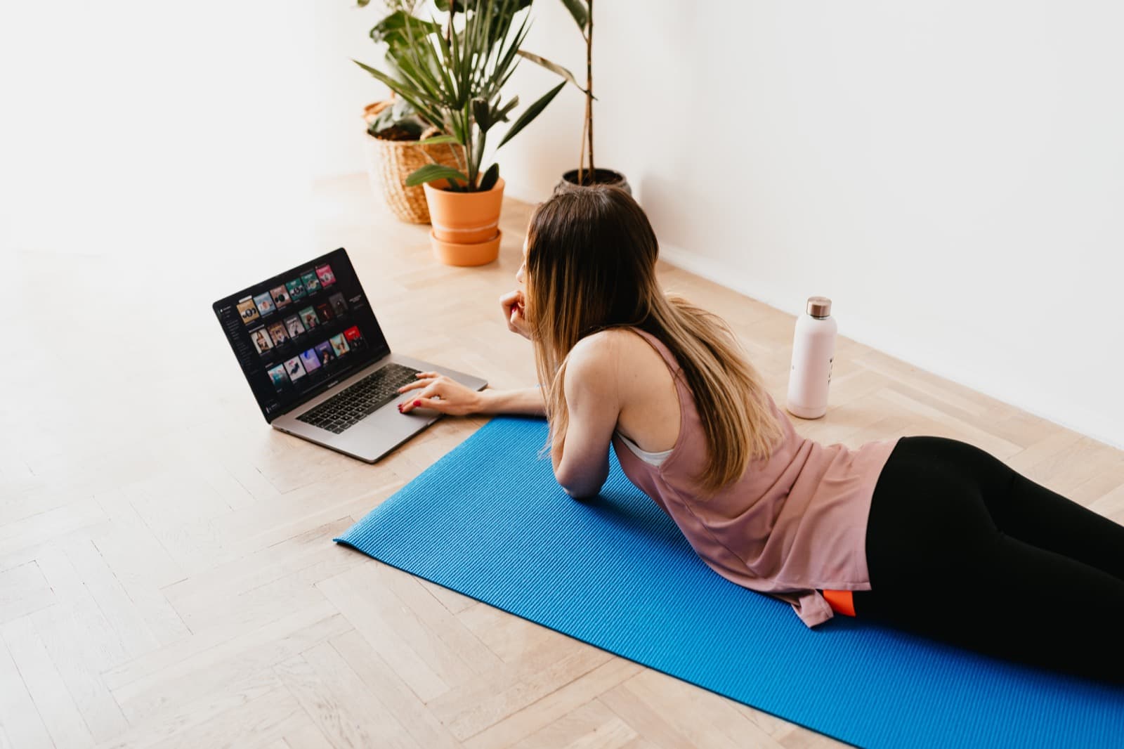 Person practising mat Pilates on a studio floor